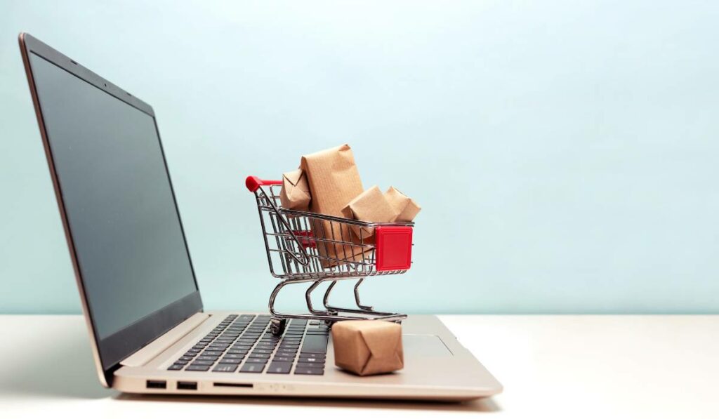 Shopping cart on laptop to show an online store.