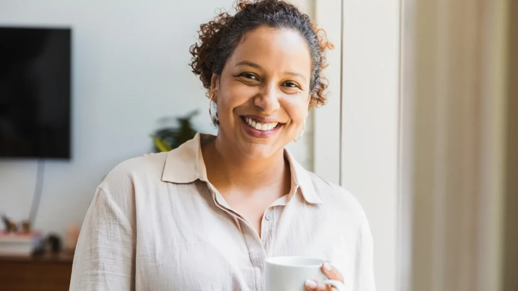 smiling middle-aged woman holding a cup of coffee