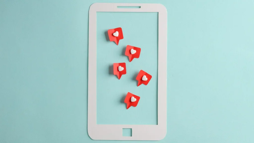 an image of a phone with red heart stickers on it