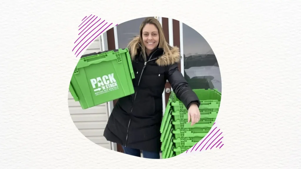 a woman holding green moving boxes