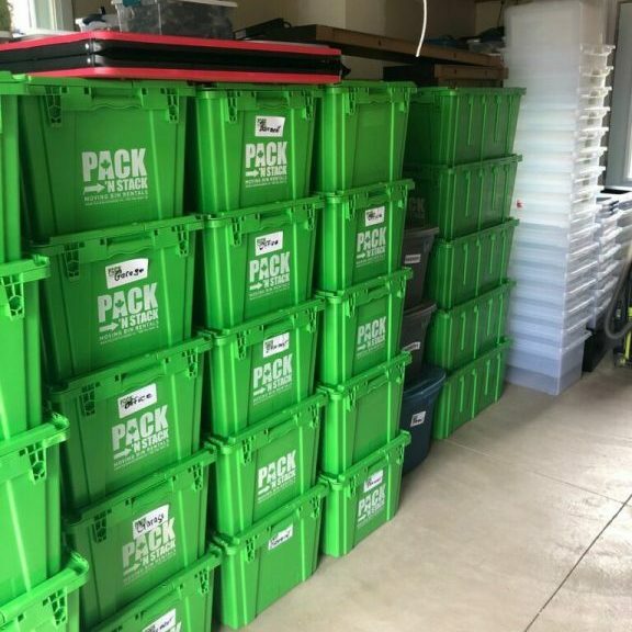 green moving boxes stacked on top of each other